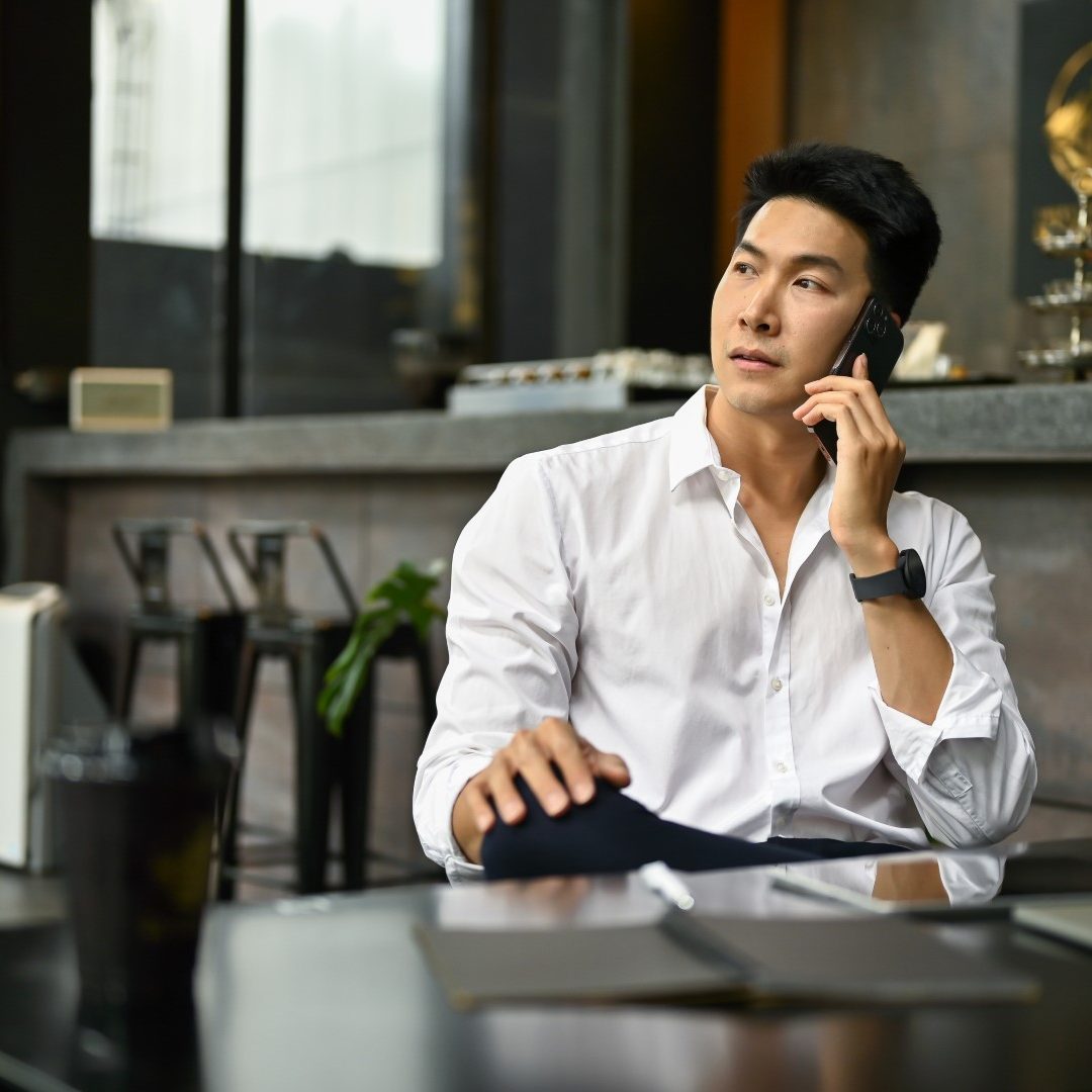 businessman-sits-modern-loft-coffee-shop-talking-phone-with-someone (1)